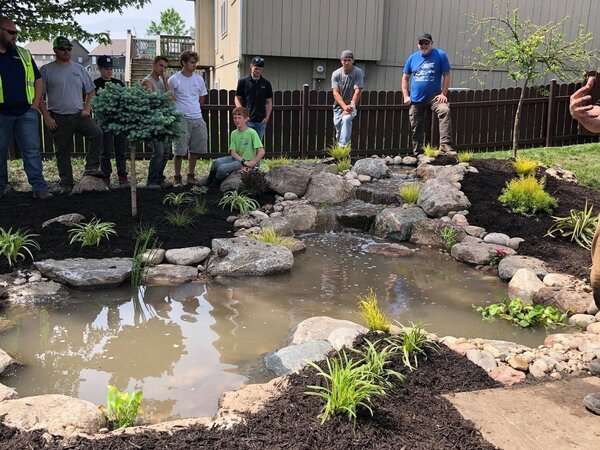 Koi pond builders in Kansas City standing around a new pond