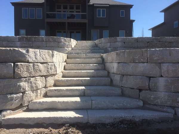 stone retaining wall with stairs built by Freedom Stone + Pondscapes