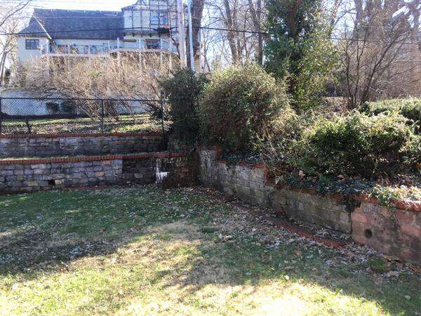 Old overgrown stone retaining wall
