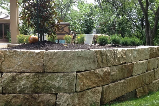 Stone block retaining wall creating a natural area and more open space