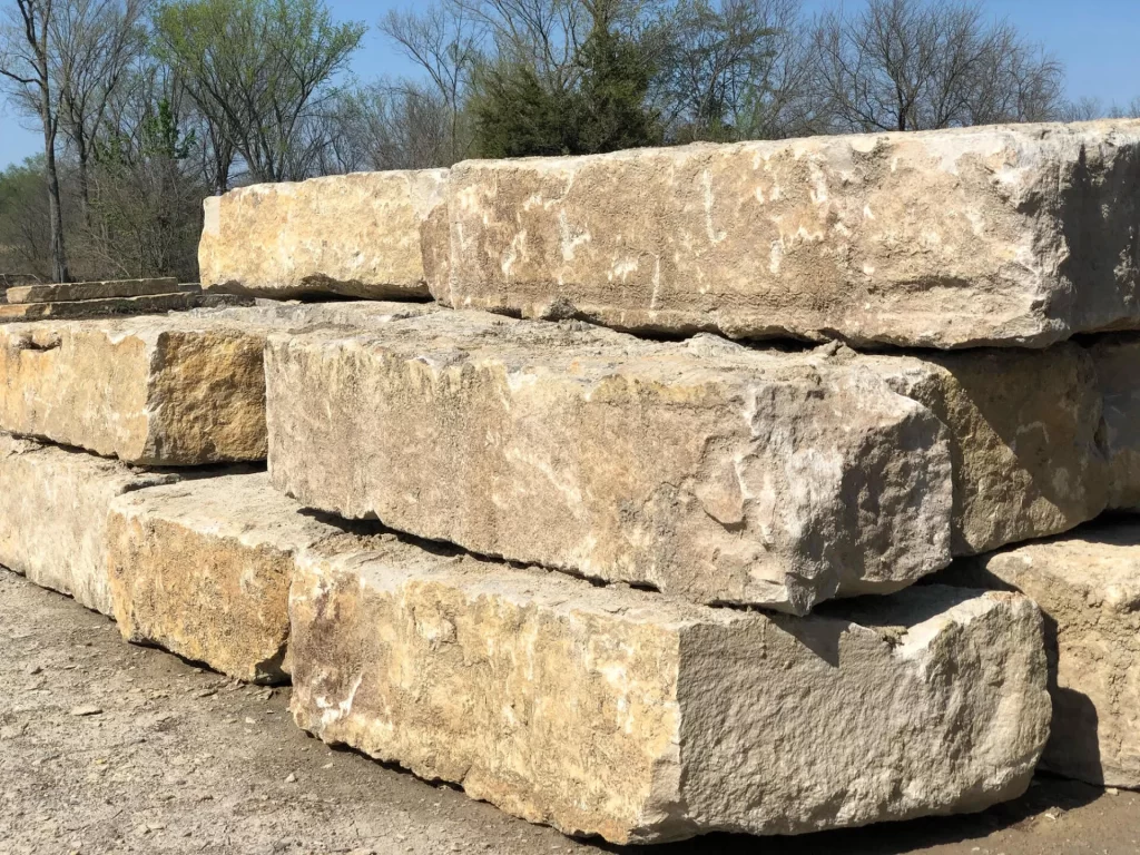 Stack of large, natural stone blocks outdoors.
